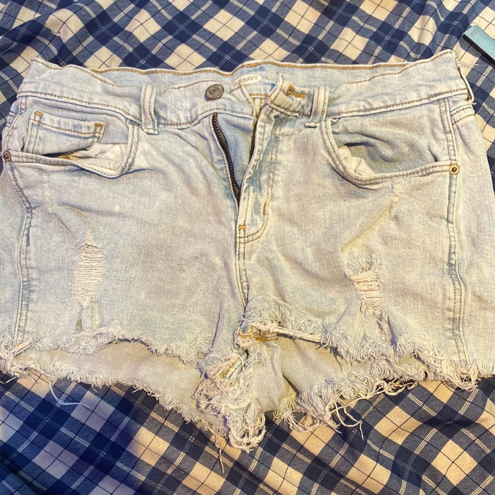 Light blue denim shorts with rips on the front.